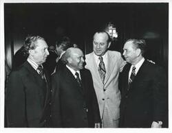["Black and white photograph print of Carl Albert in various poses with unidentified people."]