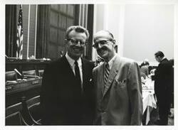 ["Black and white photograph print of Lawrence F. O'Brien and Daniel Flood posing for a picture."]