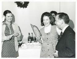 ["Black and white photograph print of Carl Albert giving a gift to one of his staff members at the Christmas party, 1971"]