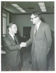 ["Black and white photograph print of Carl Albert with unidentified men."]