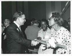 ["Black and white photograph print of Carl Albert with various unidentified people during his birthday, 1976"]