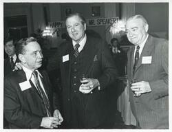["Black and white photograph print of Carl Albert speaking with unidentified people at his birthday party, 1976"]