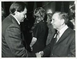 ["Black and white photograph print of Carl Albert shaking hands with an unidentified man at his birthday party, 1976"]