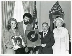 ["Black and white photograph print of Carl Albert standing with Mr. and Mrs. Sonny James on April 19, 1976"]