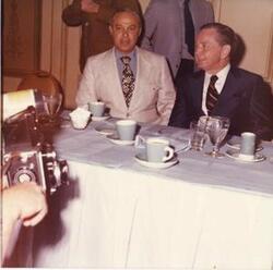 ["Color photograph print of Carl Albert speaking with unidentified women."]