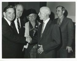 ["Black and white photograph print of Carl Albert shaking hands with James Byrnes."]