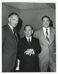 ["Black and white photograph print of Carl Albert with unidentified people."]