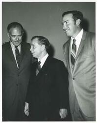 ["Black and white photograph print of Carl Albert with unidentified people."]