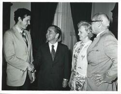 ["Black and white photograph print of Carl Albert with three unidentified people."]