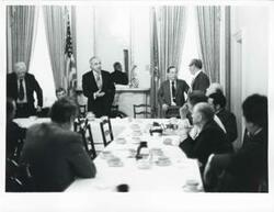 ["Black and white photograph print of Carl Albert, Thomas P. O'Neill, Robert Strauss, Russell B. Long, and several other men at a Democratic leadership conference."]