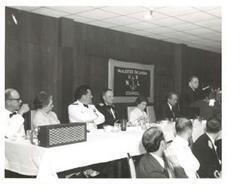 ["Black and white photograph of Carl Albert giving a speech at the United States Naval League Council in McAlester, Oklahoma on Armed Forces Day 1976."]