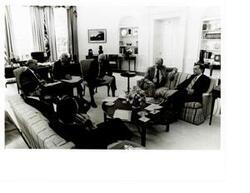 ["Black and white photograph of Carl Albert meeting with President Ford and Senator Mansfield in the White House."]