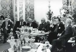 ["Black and white photograph print of Carl Albert seated with several men. House delegation trip. August 1975"]