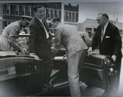 ["Black and white photograph of Carl Albert in a convertible in McAlester, Oklahoma on Armed Forces Day 1969 Possibly preparing to ride in a parade."]