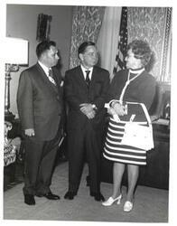 ["Black and white photograph of Carl Albert with unidentified people."]