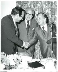 ["Carl Albert shaking hands with a man apparently after a speech."]