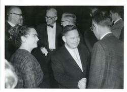 ["Carl Albert shaking hands with unidentified person."]