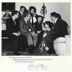 ["Carl Albert, Richard M. Nixon, and Henry Bellmon visit with a small boy who is on crutches. Another boy and perhaps the parents are in the background. May 1969 Photo is autographed by Nixon and carries the inscription \"To Congressman Carl Albert with appreciation for his service to the country and with best wishes.\" Oversized."]