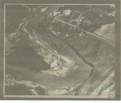 ["This aerial photograph captures a section of the Deep Fork River located in Water District 4 of Okmulgee County. It was originally attached to Items 196, 197, and 198. The photostat measures 7 1/4 by 8 13/16 inches and includes inscriptions in blue pencil."]