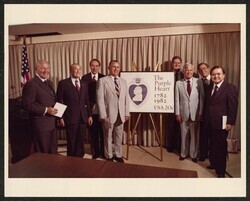 ["Caption: Purple Heart embossed envelope dedication - Pentagon 8/6/82 L-R - Robt. Michel, Strom Thurmond, Robt Dole, Bill Nichols, Howell Heflin, John Melcher, J. Denton & Daniel Inouye."]