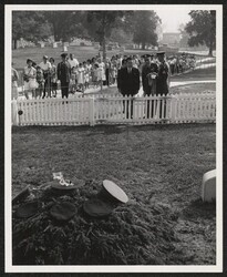 ["Caption: The Honorable Daniel Inouye, Senator of Hawaii presents an orchid lei at the grave of President John F. Kennedy in Arlington National Cemetery, Arlington, Virginia. Senator Inouye was representing the 442nd Regiment of Hawaii. Host for the ceremo"]
