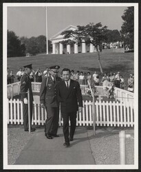 ["Caption: The Honorable Daniel Inouye, Senator from Hawaii, representing the 442nd Regiment of Hawaii leaves the gravesite of of President John F. Kennedy after he placed an orchid lei. Host for the ceremony was Lieutenant Colonel Arthur H. Ringler, Deputy"]