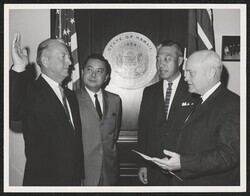 ["Caption: H. Tucker Gratz, left, of Honolulu, is shown as the oath of office is administered to him as Honolulu field office manager of the U.S. Department of Commerce by Roy W. Morgan, Chief of Office Field Services for the department. Looking on are Sena"]