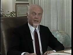 ["In the 1988 political TV ad for Democratic candidate Tom Murray, he is portrayed as a passionate and confident speaker, depicted across multiple scenes addressing large crowds from a podium. Emphasizing his leadership qualities, the ad showcases his engagements with constituents, highlighting his charismatic and confident demeanor at rallies and campaign events, all while surrounded by supportive banners and attentive audiences."]