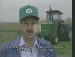 ["In a 1988 campaign ad, Republican Party candidate Paul Eugene Gillmor, sporting military attire, robustly promotes his commitment to strong national defense. The ad frequently depicts him stern and confident, amid American flags, emphasizing his veteran status as he advocates for rigorous defense policies, positioning himself as a leader in contrast to his opponent's perceived weaker stance."]