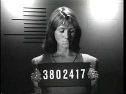 ["In the 1994 presidential campaign ad for Sandy Levin, opponent John Papa George is portrayed in a negative light. The ad features multiple scenes where George is shown with a stern expression, emphasizing his rigid anti-abortion stance and lenient views on gun control. Text overlays and settings consistently label his positions as extreme, connecting his policy stances to broader controversies around women's rights and gun laws, suggesting he is too extreme for Michigan."]