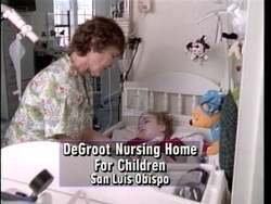 ["In a political TV ad for her 1996 presidential campaign, Republican Andrea H. Seastrand is depicted comforting medically fragile children at DeGroote home. The scenes consistently show her compassionate engagement, highlighting her care amidst bureaucratic challenges, in a nurturing, serene setting, thereby emphasizing her supportive and empathetic character."]