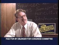 ["In the 1996 political TV ad, Republican candidate Carl Oblinger energetically rallies with supporters at local events, often accompanied by his wife, Marge. Scenes include Oblinger confidently addressing the crowd, speaking directly to the camera, and conveying a message of positivity and confidence with campaign signs in the background."]