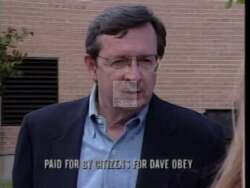 ["In Dave Obey's 1996 presidential campaign ad, emotional scenes depict a series of families grappling with the financial stress of funding college education. Fathers and students display visible anxiety over bills, job losses, and college tuition costs, showcasing the campaign's focus on the economic challenges affecting educational aspirations and family stability."]