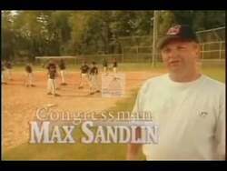 ["In the 2002 presidential campaign ad for Democratic Party candidate Max A. Sandlin, various scenes depict a seasoned, enthusiastic coach engaging with young baseball players under sunny skies. The coach, embodying community commitment, motivates and instructs the attentive youths, demonstrating leadership and teamwork through sports mentoring."]